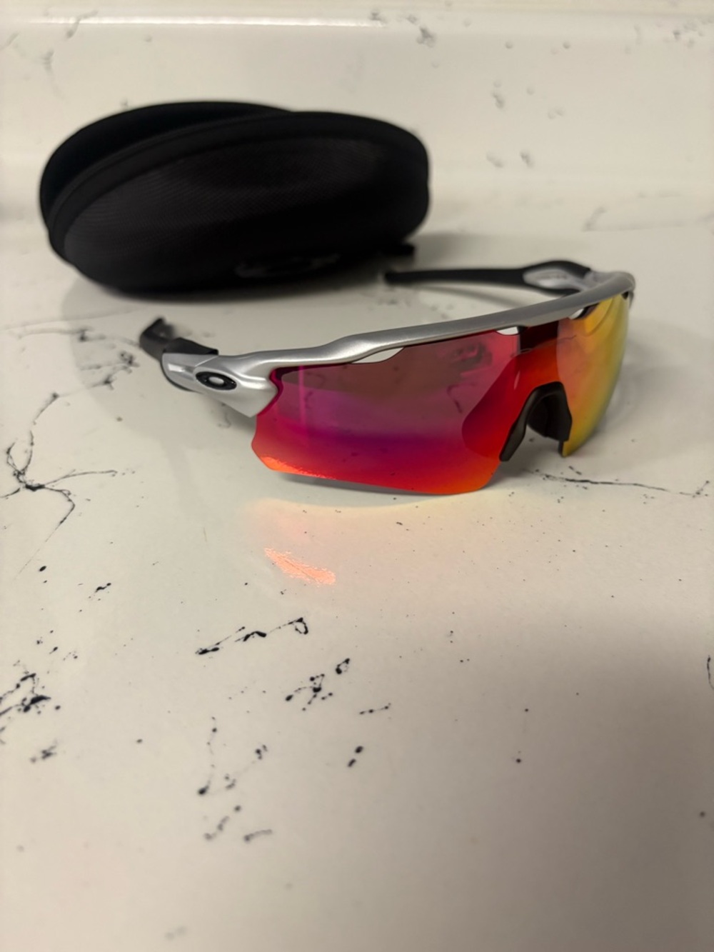 Oakley Silver Frame Sunglasses with Red-Orange Mirrored Lens